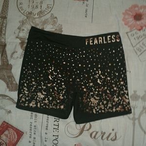 Gold and black printed "fearless" spandex shorts